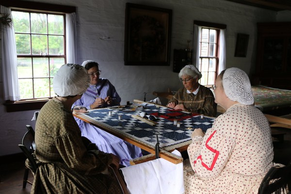 women around a table in the village